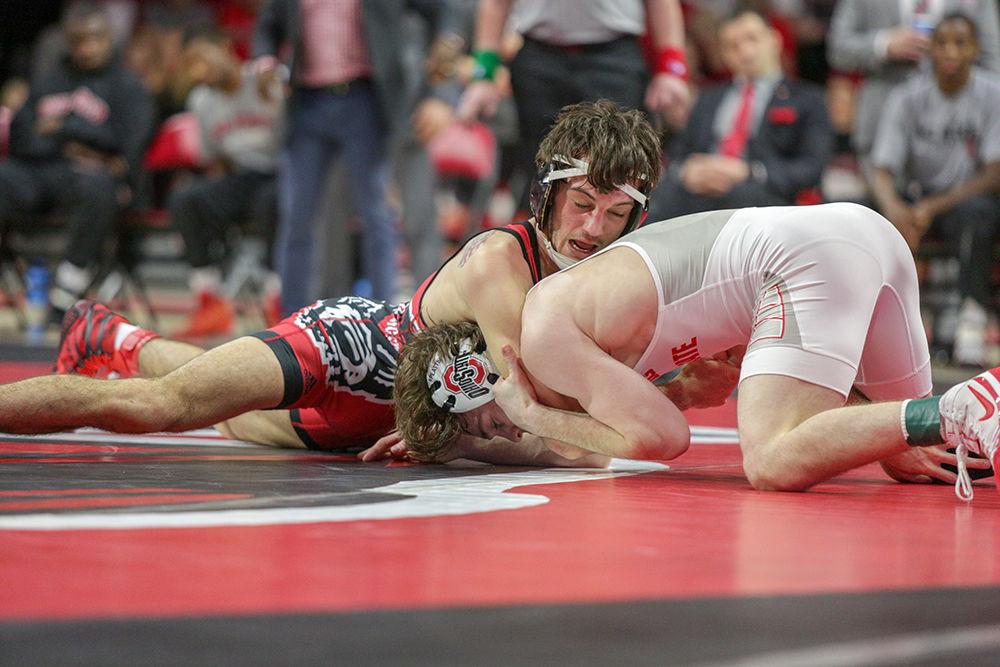 Senior Kevin Jack holds down Ohio State's Joey McKenna on Feb. 18 in Reynolds Coliseum. Jack would lose 6-2 and State fell 29-6.