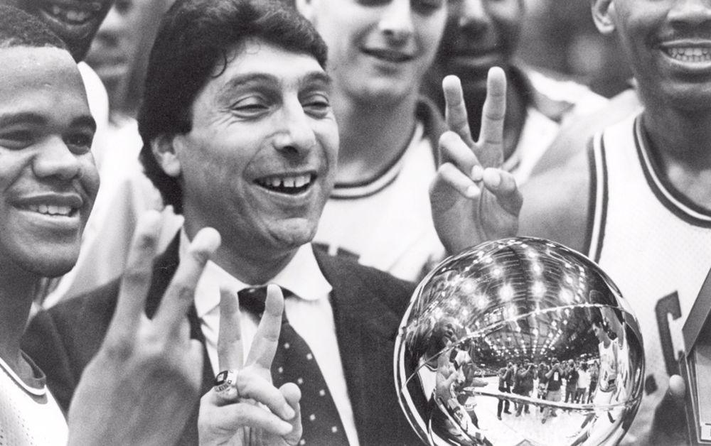 Coach Jim Valvano celebrates a Wolfpack win with his team in 1986 at the Naismith Hall of Fame Tip-Off Classic in Springfield, Massachusetts.