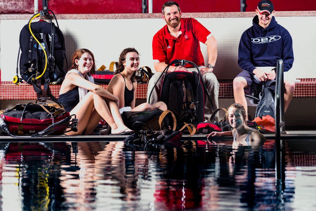 Senior Lecturer Matthew Rever sits with students at Casey Natatorium on Wednesday, Feb. 14. "My favorite thing about teaching the aquatic classes is seeing the personal growth that every student experiences. There are significant challenges, but they apply the principles of the class and overcome their obstacles," Rever said. This semester, Rever teaches skin and scuba diving, but also teaches swimming, lifeguard training, indoor group cycling and target archery. He also serves on the Faculty Senate.