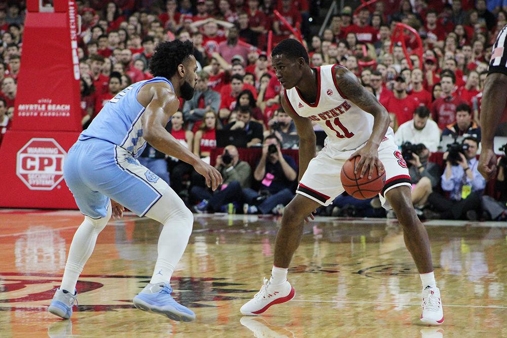 Sophomore guard Markell Johnson dribbles against University of North Carolina Chapel Hill senior guard Joel Berry II on Saturday at PNC Arena. NC State lost to UNC-CH 96-89.