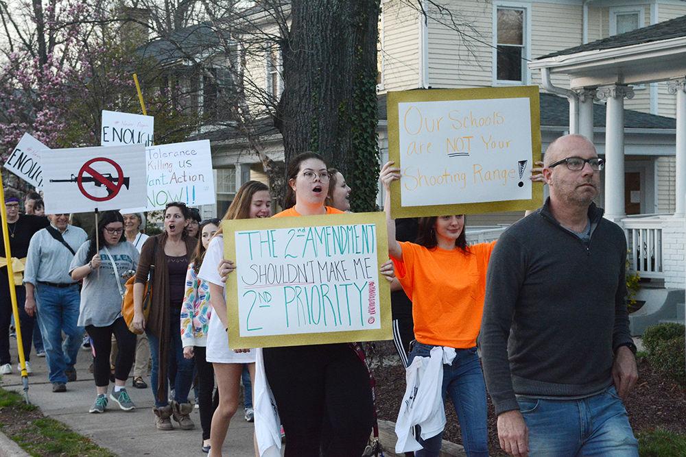 Students and parents from Raleigh and other areas march down Hillsborough Street to protest the current gun legislation in response to the recent Florida school shooting. Many brought signs and passionately spoke about their cause.