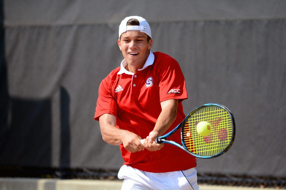 Freshman Alexis Galarneau backhands his opponent's return in a match against Miami at J.W. Isenhour Tennis Center on April 14. In a doubles match along with Michael Ogden, Galarneau picked up a 6-2 win against Miami&#8217;s Max Andrews and Jesse Flores. In a singles match against Christian Langmo, Galarneau won 6-4, 6-1. The Wolfpack defeated Miami 5-2.