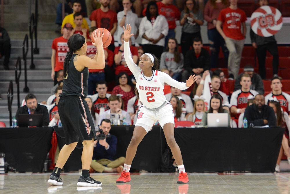 Red shirt Sophomore guard, Kaila Ealey guards a Seminoles attacker. Ealey earned the Wolfpack 14 points with 10 free throw shots, 6 rebounds, and 3 assists. The Wolfpack defeated the Seminoles by a score of 65-56 at Reynolds Coliseum on Thursday, Feb. 1.
