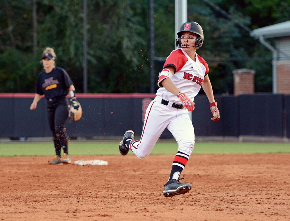 Sophomore outfielder Angie Rizzi rounds second base as she watches the ball go into the outfield during the game against ECU. The Wolfpack defended Dail Softball Stadium winning game one 8-1 and tying game two 3-3 on Friday, Oct. 6, 2017.