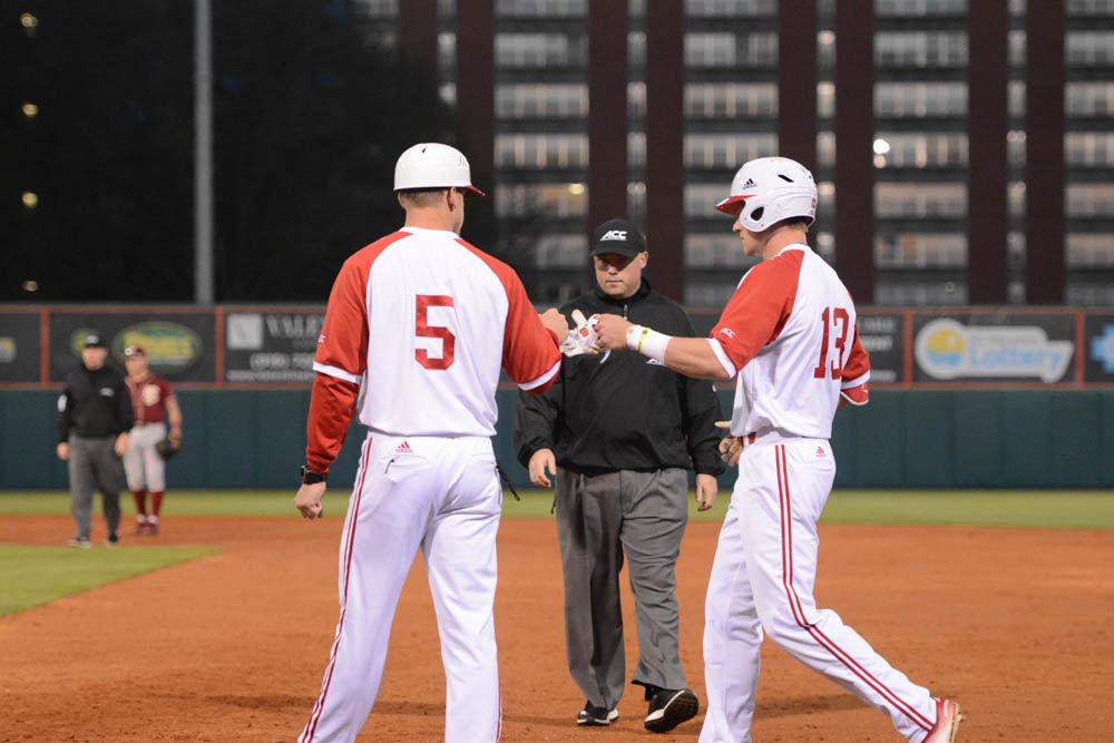 Junior outfielder Brock Deatherage knuckle touches his teammate at the baseball game against Florida State on April 8, 2017. Wolfpack won 8-4 at Doak Field.