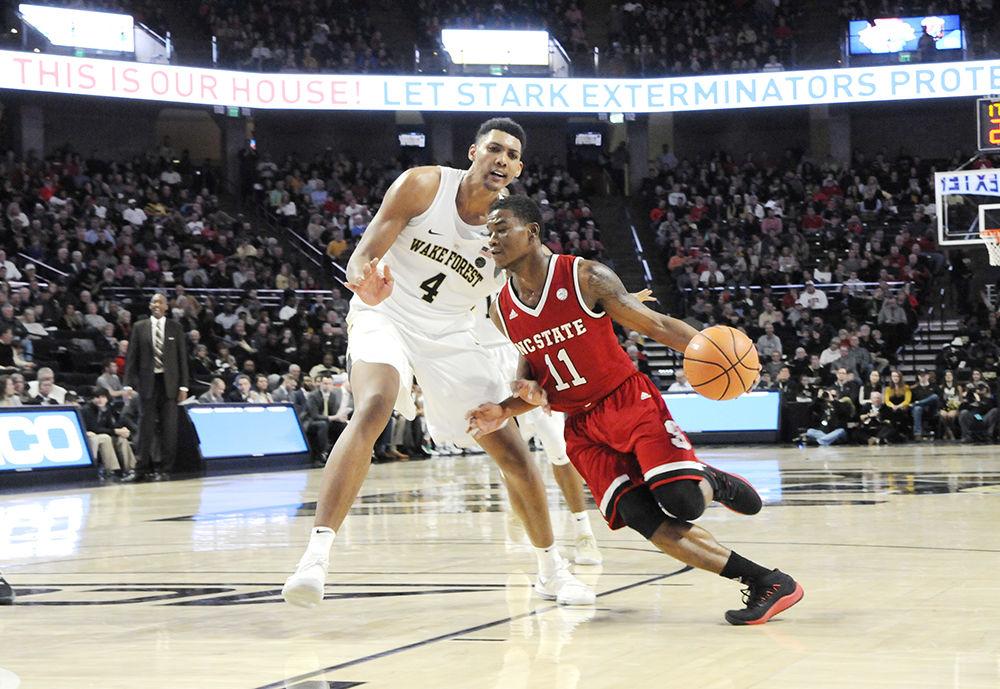 Sophomore point-guard Markell Johnson rounds the Wake Forest defense at the NC State vs. Wake Forest men's basketball game hosted at Wake Forest University in the Lawrence Joel Veterans Memorial Coliseum on Saturday. The Wolfpack won against the Demon Deacons with a final score of 90-84.