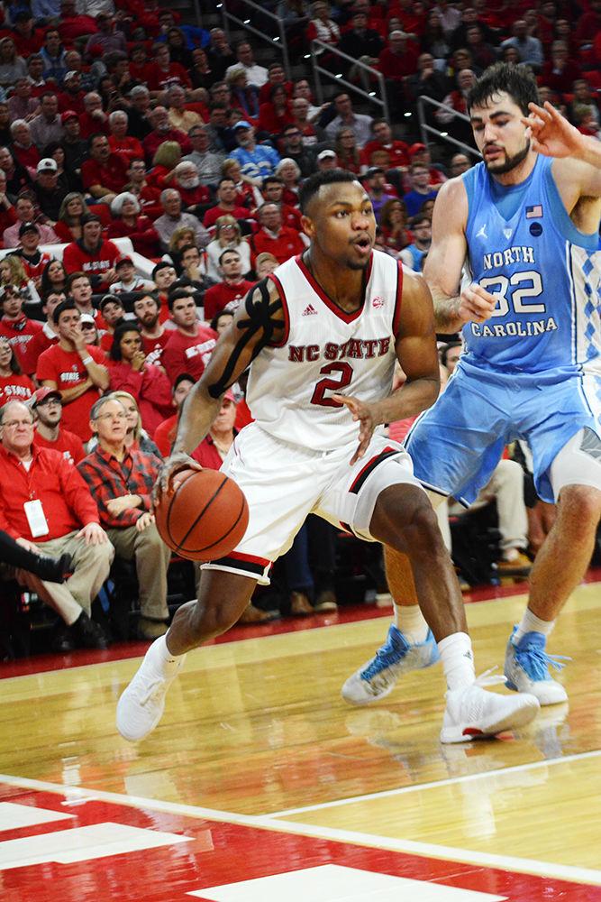 Redshirt junior guard Torin Dorn drives the baseline against No. 21 UNC on Saturday at PNC Arena. Dorn scored a team-high 21 points, along with three rebounds and three steals in the Wolfpack&#8217;s 96-89 loss.