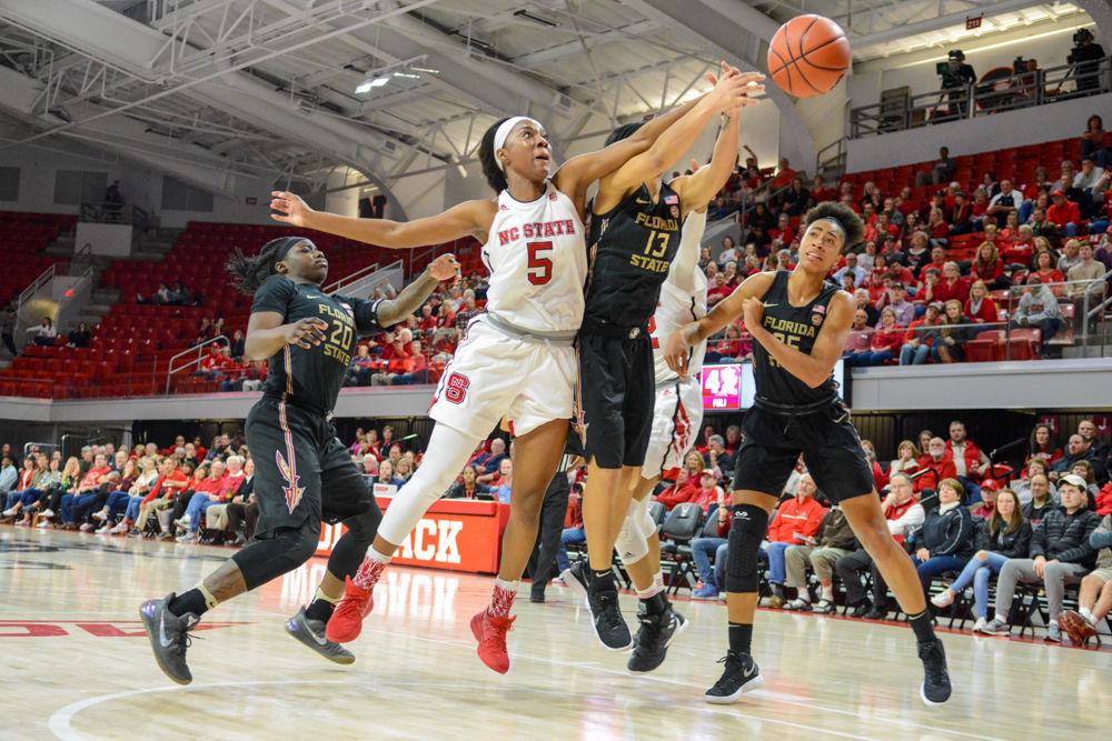 Senior forward Chelsea Nelson fights for the ball against a Seminoles player. Nelson contributed 11 points, 8 rebounds, and 4 assists to the Wolfpack. The Wolfpack won the game against the Seminoles by a score of 65-56 at Reynolds Coliseum on Thursday, Feb. 1.
