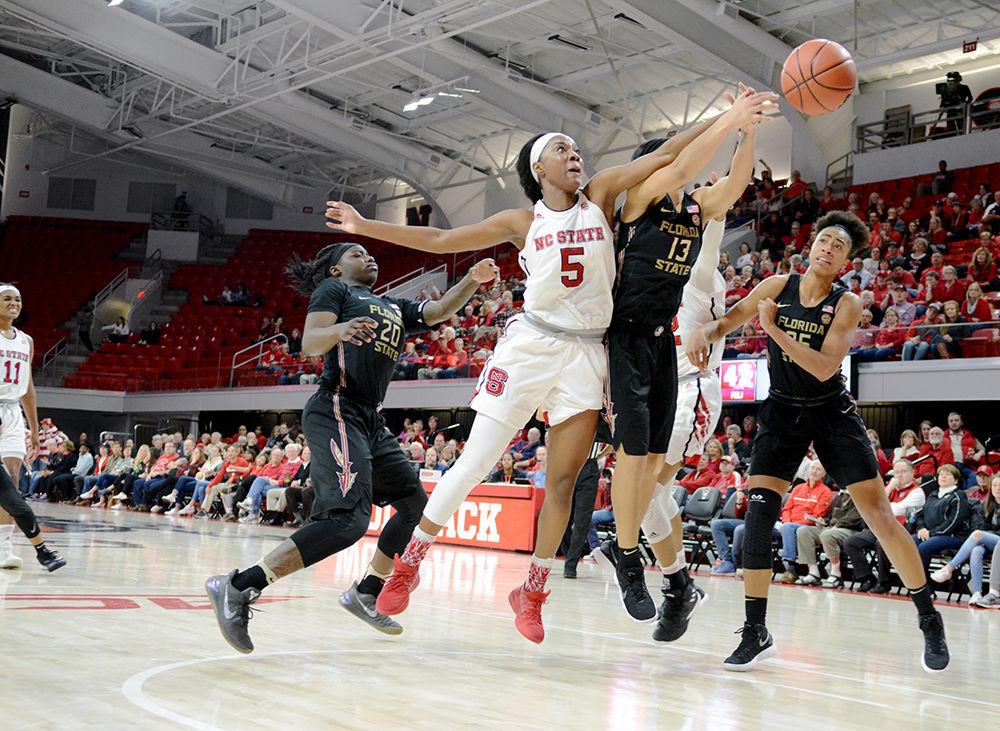 Senior forward Chelsea Nelson fights for the ball against a Seminoles player. Nelson contributed 11 points, 8 rebounds and 4 assists to the Wolfpack. The Wolfpack won the game with a score of 65-56 at Reynolds Coliseum on Thursday.