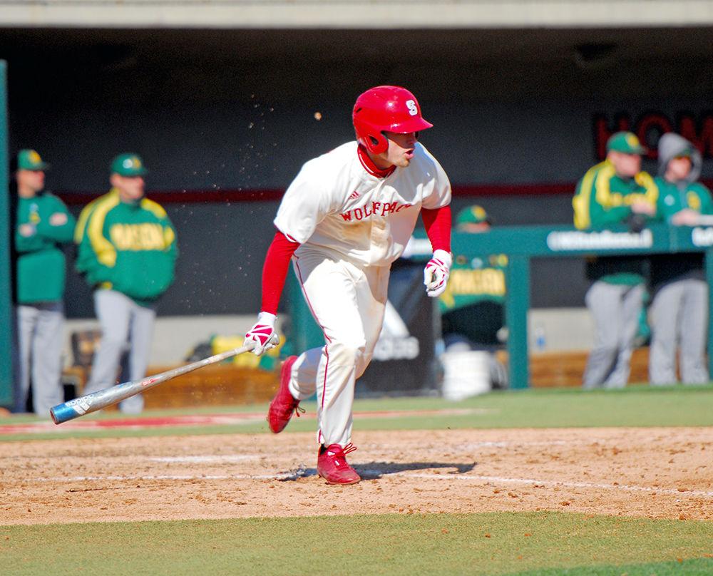 Sophomore Brett Kinneman, an outfielder in NC State's baseball team runs to first base at the Wolfpack's game against George Mason University on Mar. 15, 2017. The Wolfpack earned a strong lead in the first inning of the game leading the Patriots 5-1. The game ended with a 7-3 win for the Wolfpack.