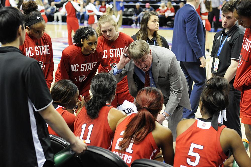 Head coach Wes Moore coaches the N.C. State women's basketball team during a time out at the ACC women's basketball semifinal against Louisville in Greensboro Coliseum on Saturday. The Wolfpack lost to the Cardinals with a final score of 64-59.