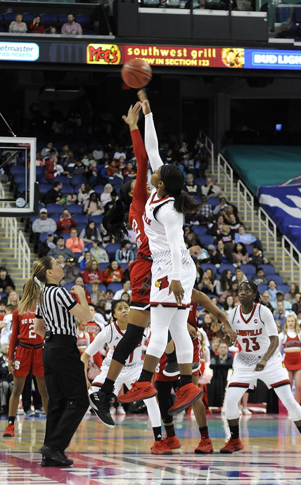 Senior center Akela Maize jumps for the ball at the start of the ACC women's basketball semifinal against Louisville in Greensboro Coliseum on Saturday. The Wolfpack lost to the Cardinals with a final score of 64-59.