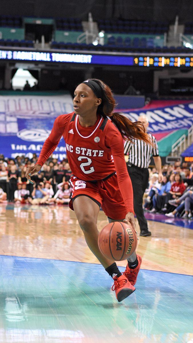 Redshirt sophomore point guard Kaila Ealey rushes the Louisville defense at the ACC women's basketball semifinal against Louisville in Greensboro Coliseum on Saturday. The Wolfpack lost to the Cardinals with a final score of 64-59.