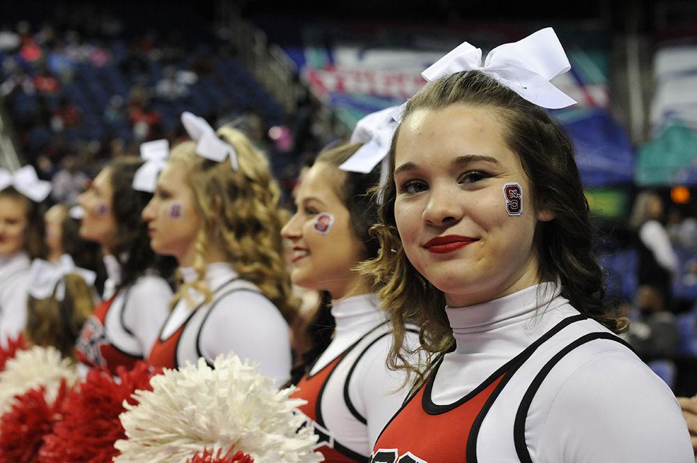 The N.C. State cheerleading team leads fans in cheers at the ACC women's basketball semifinal against Louisville in Greensboro Coliseum on Saturday. The Wolfpack lost to the Cardinals with a final score of 64-59.