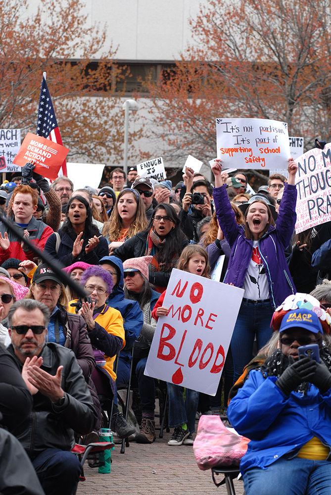 Protesters chant and cheer while holding their signs high at the "March for Our Lives" in downtown Raleigh on Saturday, March. 24, 2017. The protest called for "common sense gun reform" in the wake of the multitude of mass shootings that have taken place in the United States school system.