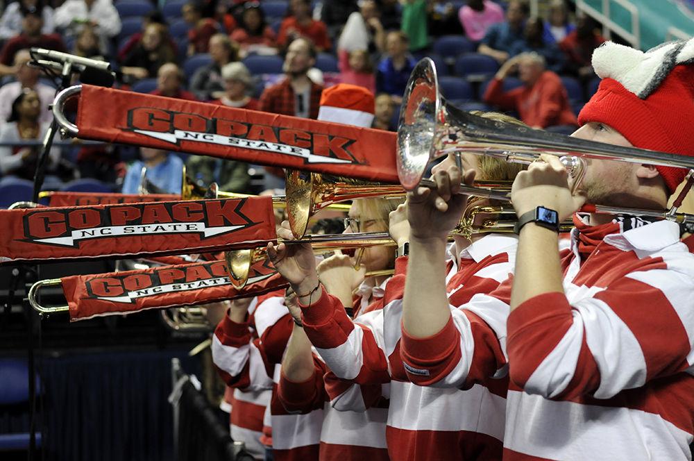 The trombone section of the N.C State varsity band plays the fight song during the ACC women's basketball semifinal against Louisville in Greensboro Coliseum on Saturday. The Wolfpack lost to the Cardinals with a final score of 64-59.