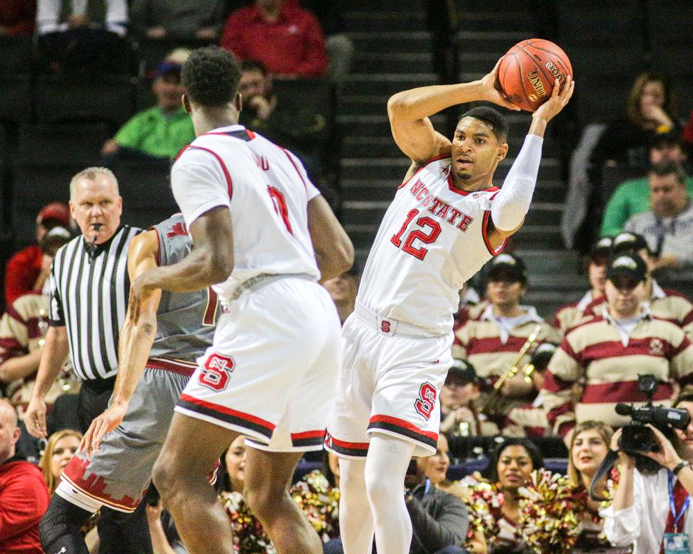 Graduate guard Allerik Freeman leans back to make the pass to senior forward Abdul-Malik Abu. The Pack was unable to pull the off the comeback after the lackadaisical first half to fall 91-87 to Boston College on Wednesday, March 7 in Barclays Center in Brooklyn, NY.
