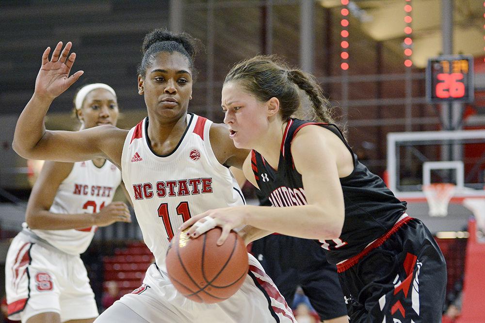 Redshirt junior guard Kiara Leslie defends an attacking Davidson Wildcat during the game in Reynolds Coliseum. The Wolfpack would go on to win 73-49 on Sunday, Nov. 12, 2017.