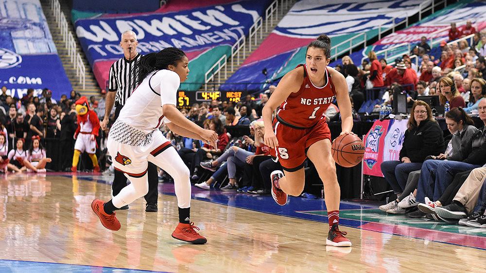 Sophomore point guard Aislinn Konig rushes the Louisville defense at the ACC women's basketball semifinal against Louisville in Greensboro Coliseum on Saturday. The Wolfpack lost to the Cardinals with a final score of 64-59.