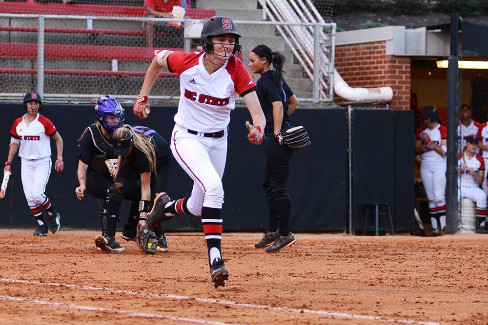 Sophomore outfielder Jade Caraway runs toward first base after a bunt during the game against ECU. The Wolfpack defended their home, winning game one 8-1 and tying game two 3-3 in Dail Softball Stadium on Friday, Oct. 6, 2017.