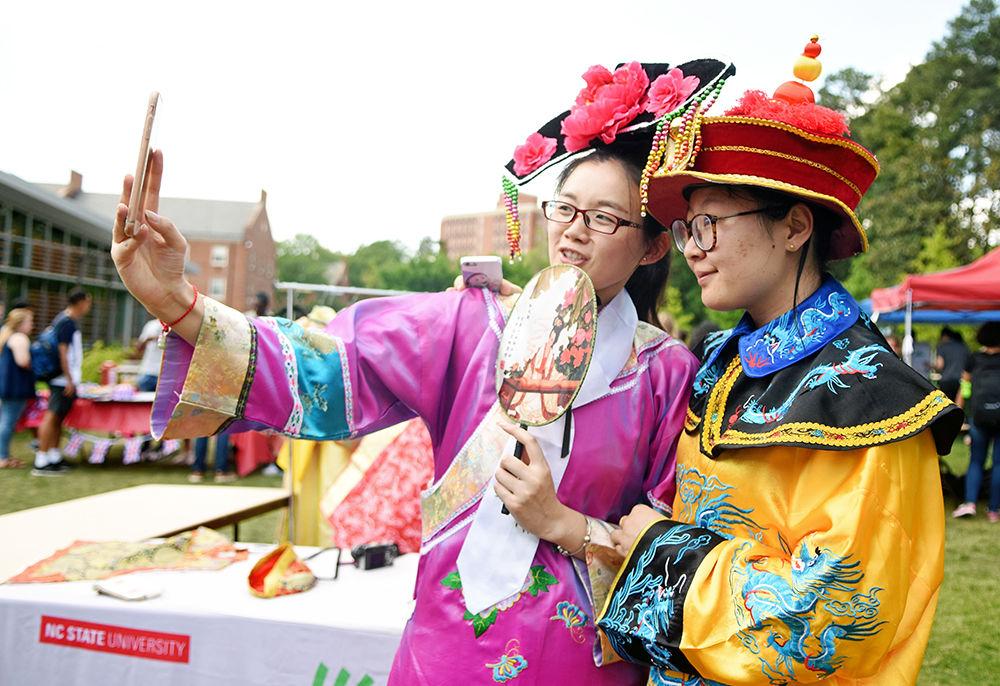 Wenhui Geng and Grace Du, graduate students studying forest biomaterials, take a selfie with Geng's phone of them wearing the traditional garb of the Chinese emperor's wife and emperor respectively at the International Festival at Stafford Commons April 21, 2017.&#160; The International Festival, sponsored by Student Involvement, Student Government, the Multicultural Student Affairs Office and the Office of International Services, gave students the opportunity to learn about different cultures around the world.