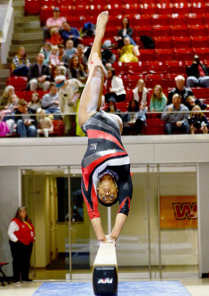 Chelsea Knight, a senior studying psychology, performs on the balance beam during the gymnastics match against New Hampshire in Reynolds Coliseum on Friday, March 2. The Wolfpack beat the Wildcats 196.075-195.650 bringing its win record to 13-6.