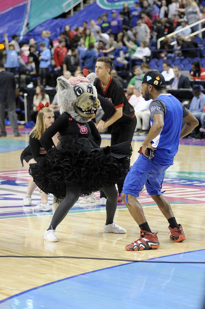 Ms. Wuf dances with an emcee at the ACC women's basketball quarterfinal against Duke University in Greensboro Coliseum on Friday, Mar. 2, 2018. The Wolfpack was victorious against the Blue Devils with a final score of 51-45.