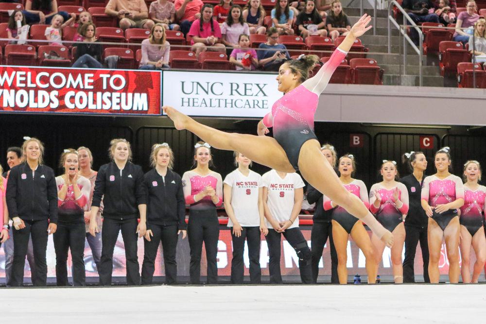 Sophomore Drew Grantham leaps into the air during her floor routine. Grantham scored a career-high on floor with a 9.850 in the 195.725-193.325 win over William and Mary on Saturday, Feb. 24 in Reynolds Coliseum.