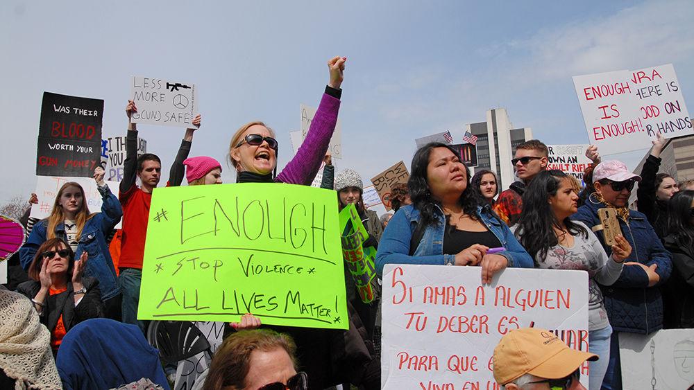 Protesters chant and cheer while holding their signs high at the "March for Our Lives" in downtown Raleigh on Saturday, March. 24, 2017. The protest called for "common sense gun reform" in the wake of the multitude of mass shootings that have taken place in the United States school system.