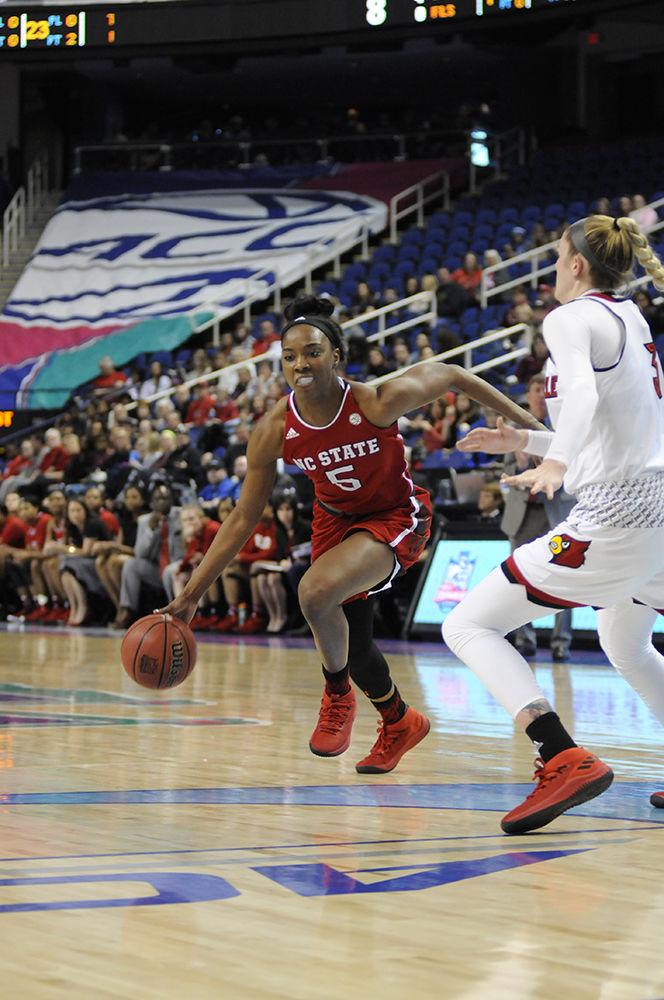 Senior forward Chelsea Nelson rushes the Louisville defense at the ACC women's basketball semifinal against Louisville in Greensboro Coliseum on Saturday. The Wolfpack lost to the Cardinals with a final score of 64-59.