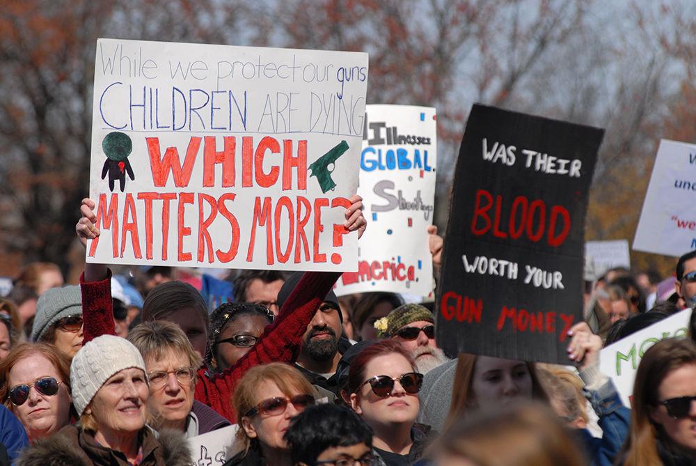 Protesters hold signs and listen to the protest speakers at the "March for Our Lives" in downtown Raleigh on Saturday, March. 24, 2017. The protest called for "common sense gun reform" in the wake of the multitude of mass shootings that have taken place in the United States school system.