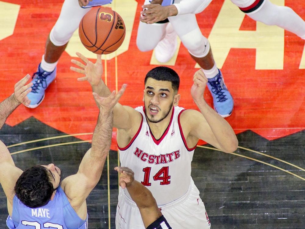 Sophomore center Omer Yurtseven goes up against UNC-Chapel Hill's Luke Maye for the tip prior to the basketball team&#8217;s 96-89 loss to UNC in PNC Arena on Feb. 10.