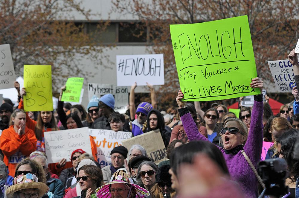 Protesters chant and cheer while holding their signs high at the "March for Our Lives" in downtown Raleigh on Saturday, March. 24, 2017. The protest called for "common sense gun reform" in the wake of the multitude of mass shootings that have taken place in the United States school system.
