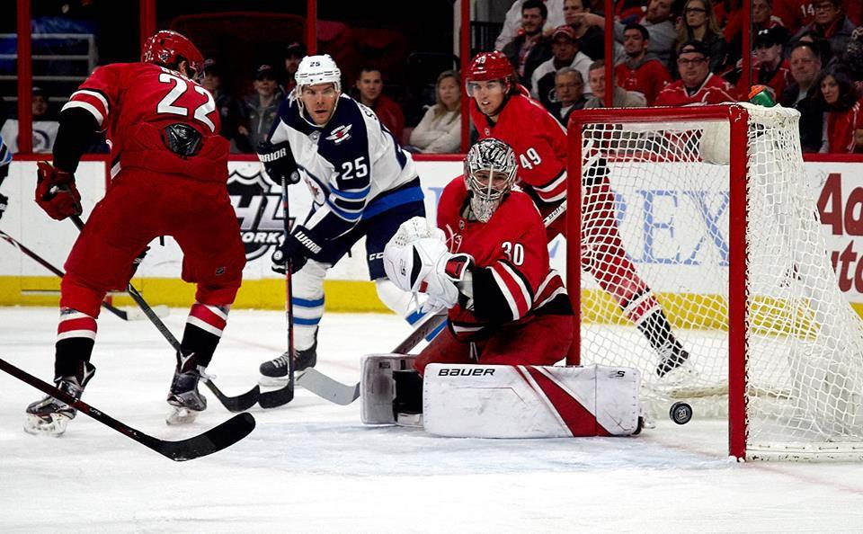 Hurricanes goalie Cam Ward and Jets forward Paul Stastny watch as a puck goes slightly wide during a in the second period of a 3-2 Hurricanes loss at PNC Arena on Sunday March 4. Winnipeg had only four shots on goal in the second period and a total of 23 in the game.