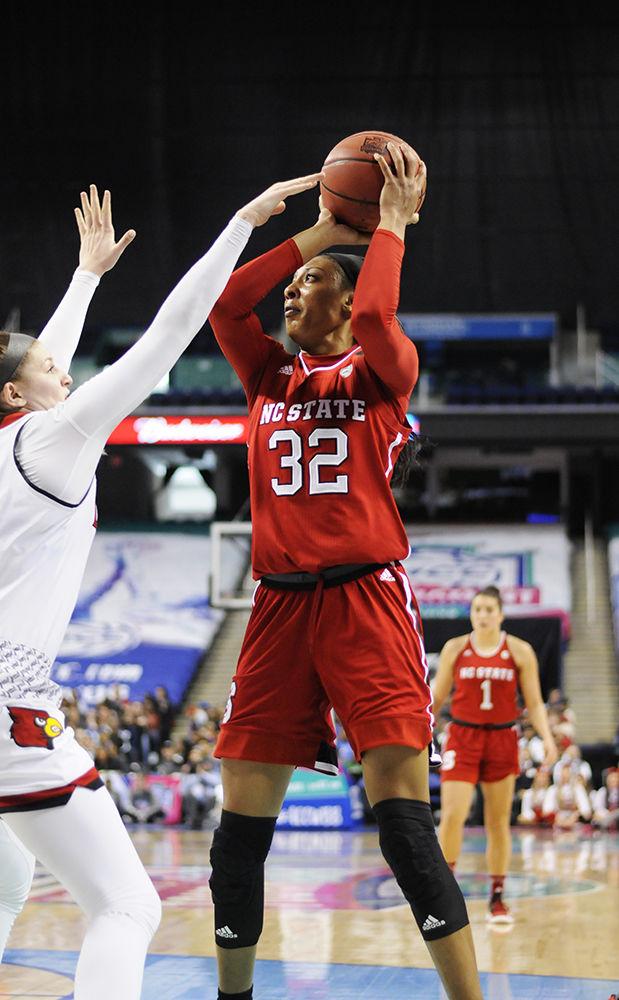 Senior center Akela Maize looks for an opening to shoot the ball at the ACC women's basketball semifinal against Louisville in Greensboro Coliseum on Saturday. The Wolfpack lost to the Cardinals with a final score of 64-59.