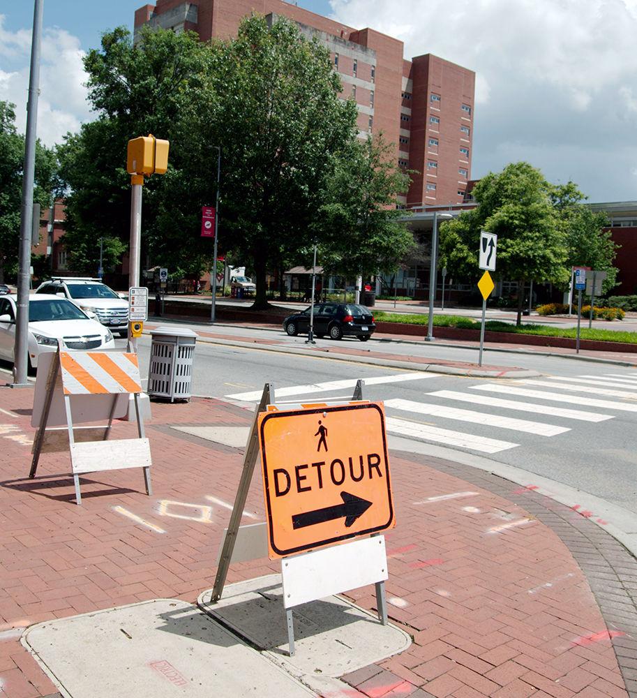 A detour sign tells pedestrians to avoid the construction on Hillsborough Street across from D.H. Hill Library on July 5, 2017. The ongoing construction on Hillsborough Street means that pedestrians must find their way along the road through alternate paths to avoid the work areas. The construction has also caused problems with traffic coming in and out of Raleigh.