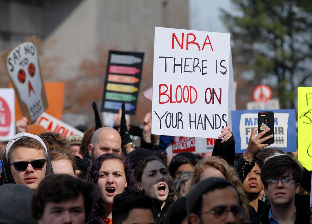 Protesters chant and hold up their signs at Halifax Mall in downtown Raleigh at the "March for our Lives" on Saturday. The protest took place in the wake of multiple school shootings and supported the idea of pushing legislators toward "common sense gun reform".