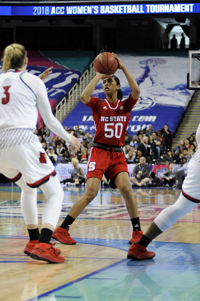 Redshirt junior point guard Armani Hawkins shoots the ball for a field goal at the ACC women's basketball semifinal against Louisville in Greensboro Coliseum on Saturday. The Wolfpack lost to the Cardinals with a final score of 64-59.
