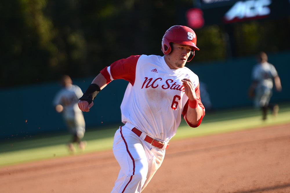 Junior outfielder Brett Kinneman runs onto first base during the series against Bowling Green in Doak Field at Dail Park on Friday. The Wolfpack beat the Falcons 11-1, for their ninth win this season.