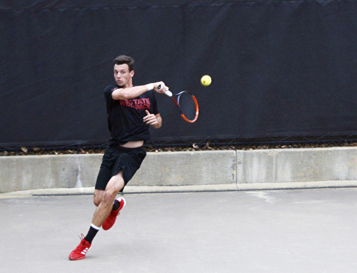 Junior Michael Ogden returns a serve from a Notre Dame opponent during the tennis match on Friday at J.W. Isenhour Tennis Center. Ogden and his doubles partner defeated the Notre Dame doubles team 6-2. Ogden lost his singles match.