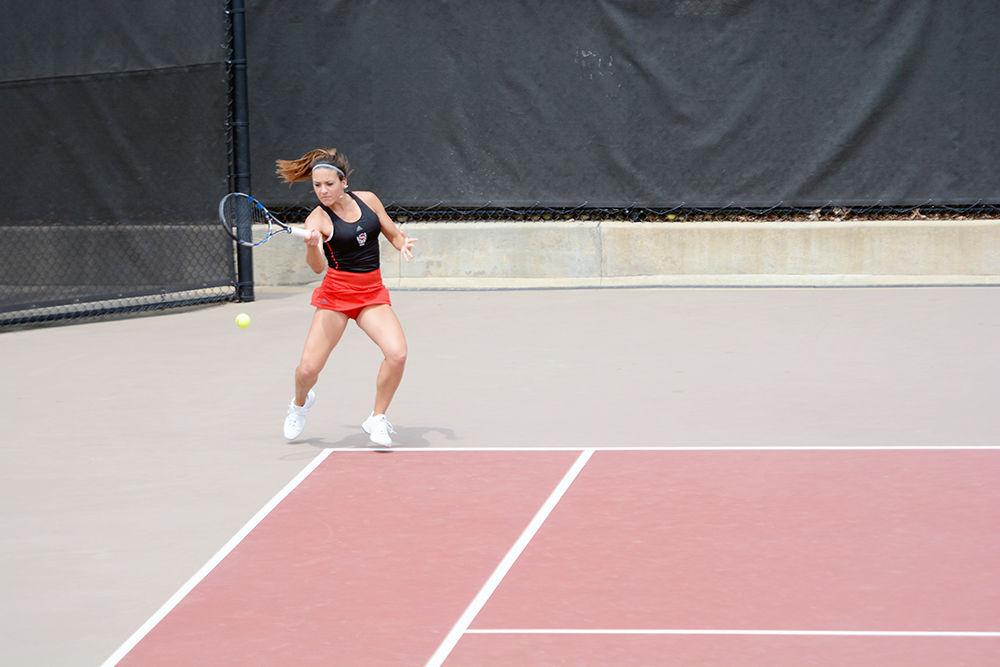 Junior Claudia Wiktorin returns the ball during the tennis match against Syracuse on Sunday at J.W. Isenhour Tennis Center. Her doubles match with sophomore teammate Anna Rogers was unfinished with a final score of 4-4. Wolfpack was defeated Sunday afternoon with an overall score of 3-4.