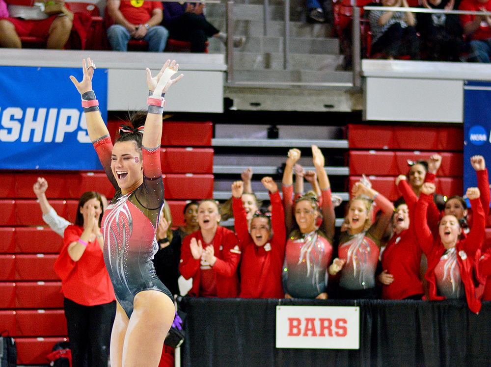 Junior Caitlyn Fillard celebrates after landing from the uneven bars at the NCAA Regional Championship in Reynolds Coliseum on Saturday. She scored 9.775 in this event and the team came in 3rd place overall.