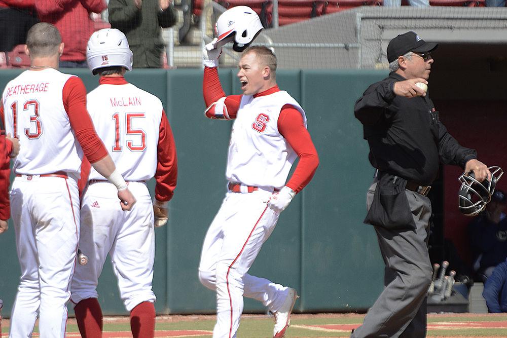 Junior outfielder Brett Kinneman celebrates his home run with his teammates on Sunday, March 25 at Doak Field. Kinneman went 2-5 with one home run and 2 runs batted in as the Wolfpack won 9-6.