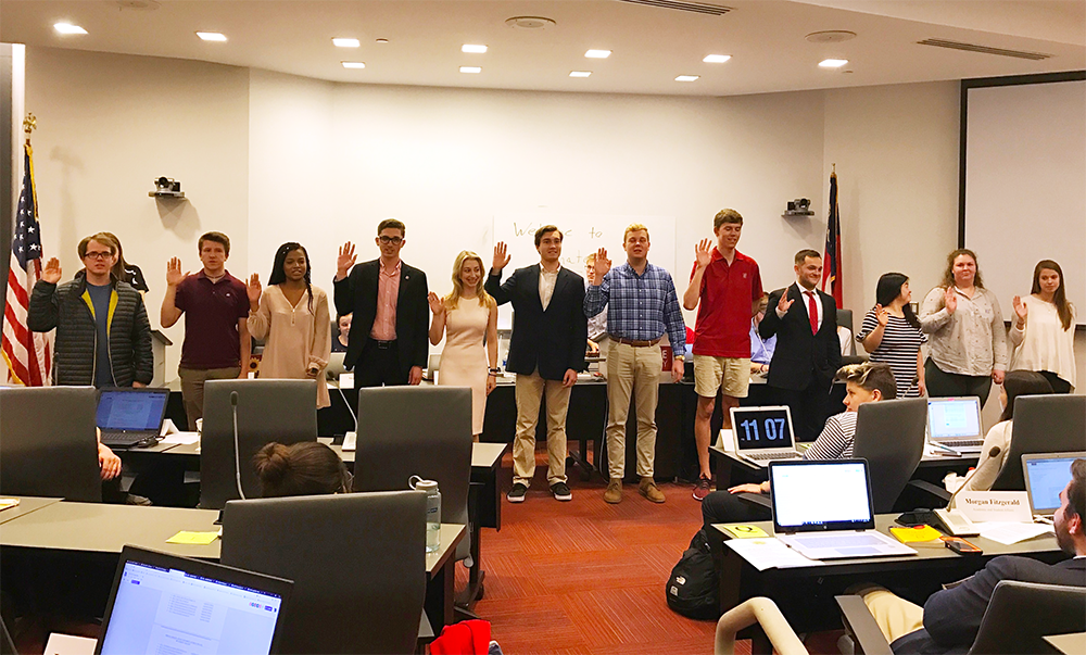 Newly appointed Cabinet members take the Oath of Office in the second meeting of the 98th session in Student Governance Chambers on Wednesday.