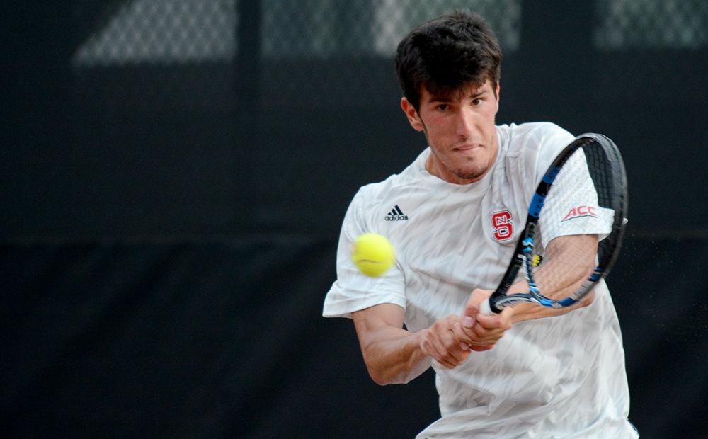 Sophomore Ivan Saveljic returns his opponent's serve with a backhand in a match against Miami University at JW Isenhour Tennis Court on April 14, 2017. The doubles match with sophomore Igor Saveljic ended in a 6-4 win.