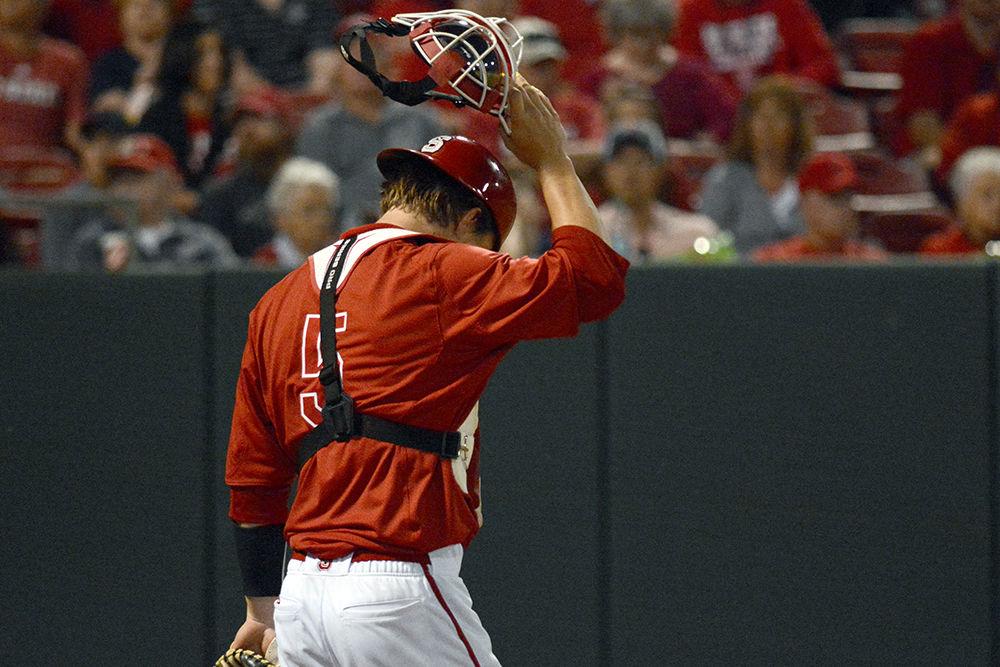 Freshman catcher Patrick Bailey adjusts his mask after a UNC hit on Saturday at Doak Field. Bailey went 2-4 with 1 run scored and 1 RBI as the Wolfpack lost 8-6.