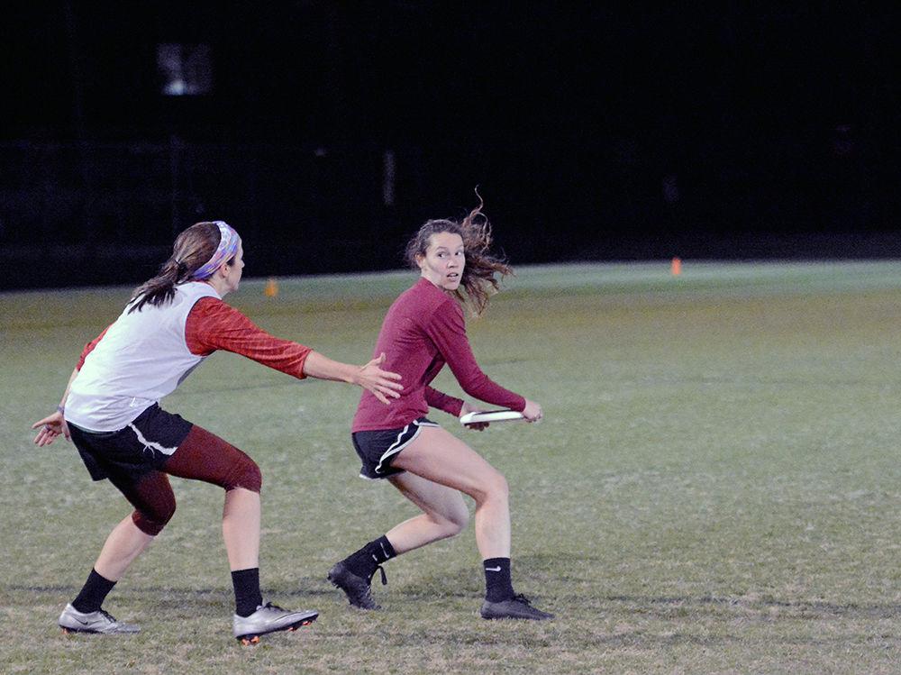 Second-year, Rowan Jaynes, pitches the frisbee to a teammate during practice on Thursday. This year the Women's Club Ultimate Frisbee team received a bid to play in the USA Ultimate Division I College Championship.