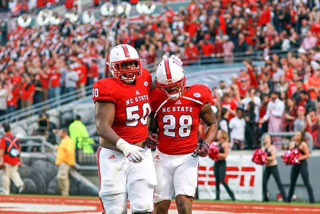 Sophomore outside guard Tony Adams congratulates Sophomore tight end Jaylen Samuels after his touchdown. Samuels had 65 yards on the ground and 74 yards through the air including two touchdowns. The Wolfpack lost homecoming 56-41 to No. 3 Clemson on October 31st in Carter-Finley Stadium.