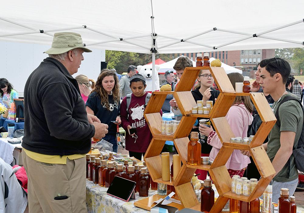 Students look at different products sold by Baxter's Bees during the annual Earth Fair on Wednesday in the Brickyard. Clubs and organizations gathered to educate students about sustainability on campus. Baxter's Bees sells many products, ranging from honey to deodorant.