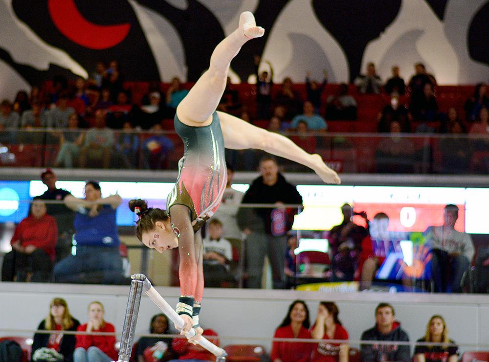 Freshman Lauren Kent performs on the bars at the NCAA Regional Championship in Reynolds Coliseum on Saturday. She scored a 9.800 in this event.